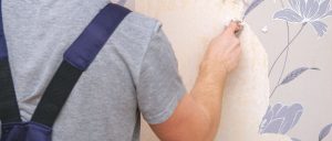 A man is making wallpaper repairs